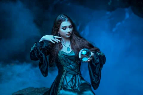 The witch with magic ball in her hands causes a spirits Stock Photos