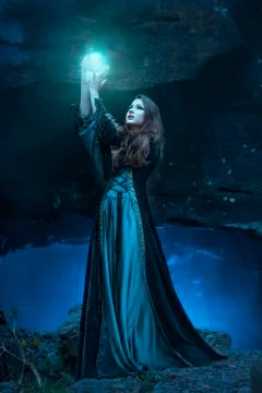 The witch with magic ball in her hands causes a spirits Stock Photos