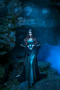 The witch with magic ball in her hands causes a spirits Stock Photos