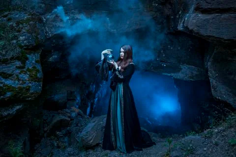 The witch with magic ball in her hands causes a spirits Stock Photos