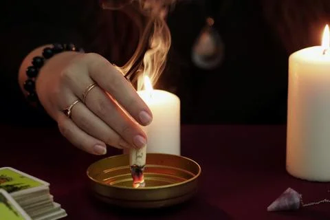 A witch make ritual and burns paper with spell. Divination and wicca concept. Stock Photos
