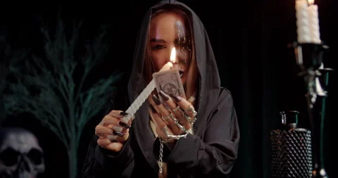 Witch performing ritual with tarot card and ceremonial dagger Stock Footage 319602152