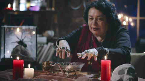 Witch performing ritual with two snakes and bowl of water Stock Footage 136887150