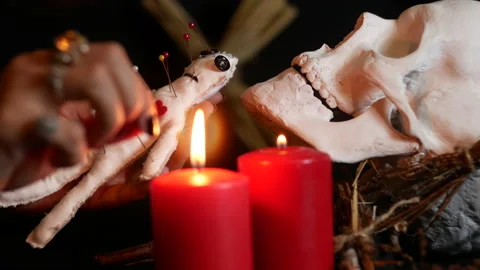 The witch pierces the voodoo doll with needles and curses the man Stock Footage 235004514
