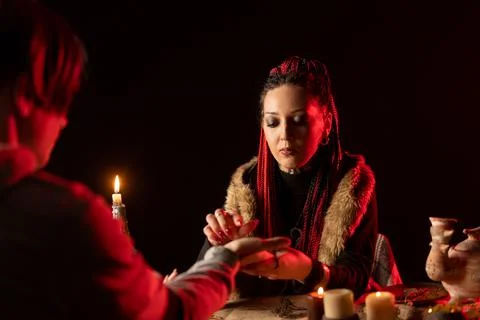 The witch predicts the future. Black magic. Mystical interior of the room. Stock Photos