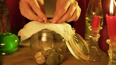 Witch prepares a green potion in jar Stock Footage 162350124