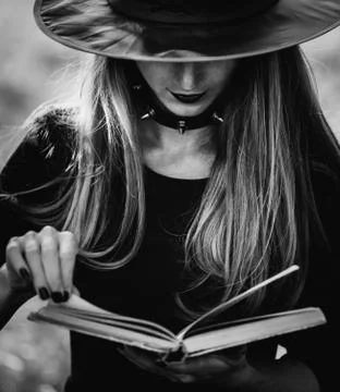 Witch reading a book Stock Photos