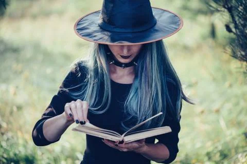 Witch reading a book Stock Photos