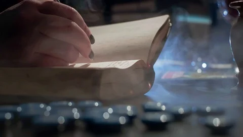 The witch is reading a magic book. Makes notes of a ritual ceremony. Conducts a Stock Footage 125738993
