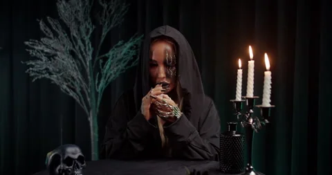 Witch reading tarot cards by candlelight Stock Footage 319558203