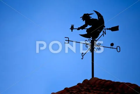 Witch shape on weather vane Stock Photos