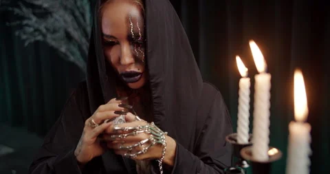 Witch shuffling tarot deck in candlelight Stock Footage 319593492