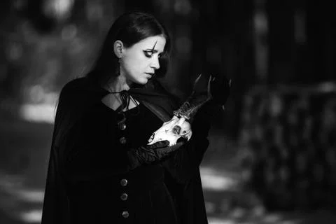 The witch with a skull in the forest Stock Photos