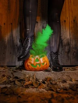 The witch stepped on a pumpkin with smoke Stock Photos