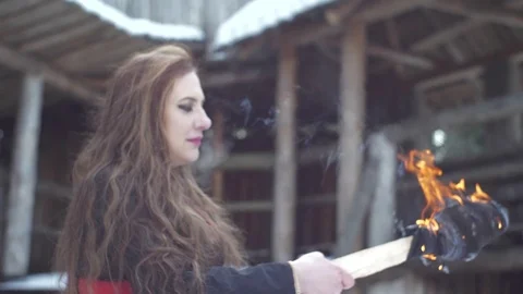 Witch with torch and medieval background in slow-mo flat image Stockbeeldmateriaal 89121450