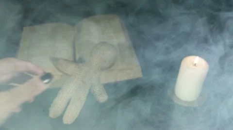 Witch voodoo doll with a pin pierces in the smoke Stock Footage 18698477