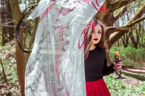 Witch in the woods with a candle Stock Photos