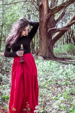 Witch in the woods with a candle Stock Photos