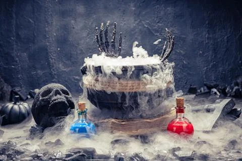 Witchcraft setup with bubbling pot and potions. Stock Photos