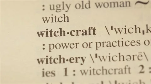 Witchcraft word on dictionary page reading letters Vídeos de archivo 267176357