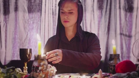 Witcher fortune teller psychic looks at photo with lost person and tries to find Video stock 143511664