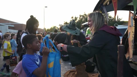 Witches Hand Out Candy at Trunk-Or-Treat Stock Footage 318105361