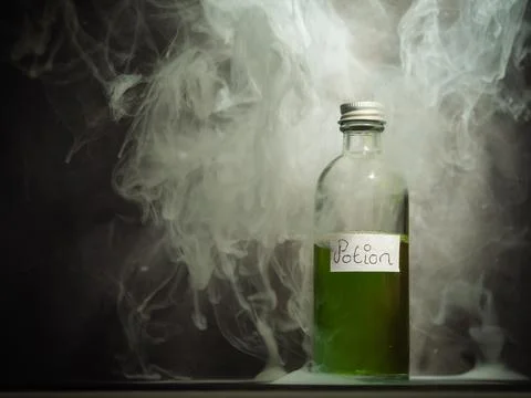 Witches potion in a bottle with smoke close up shot 库存照片