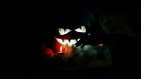 Witch’s hand puts a candle. Jack-o-lantern. Scary smoke. Halloween. Stock Footage 141857307