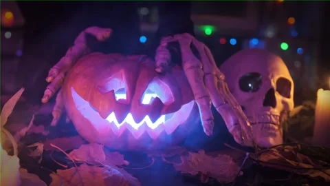 Witch's hands transform a pumpkin into a Jack O'Lantern during a Halloween party Stock Footage 252196870