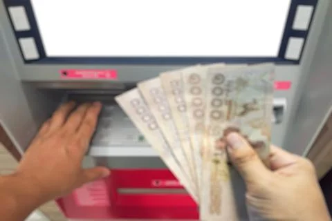 Withdraw bank notes in the hand of five thousand baht from the ATM Stock Photos
