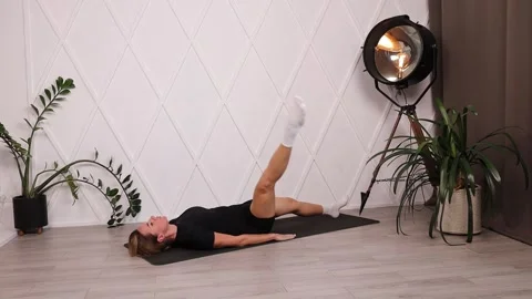 Withdrawal of a straight leg to the side from the lying position on the back Stock Footage 280160011