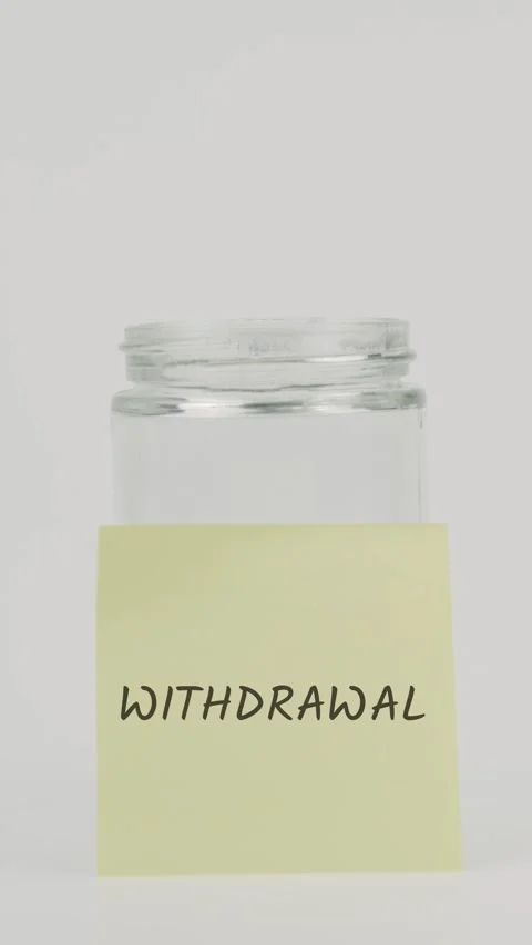 Withdrawal text or word on yellow sticky note attached to glass jar Stock Footage 311807068