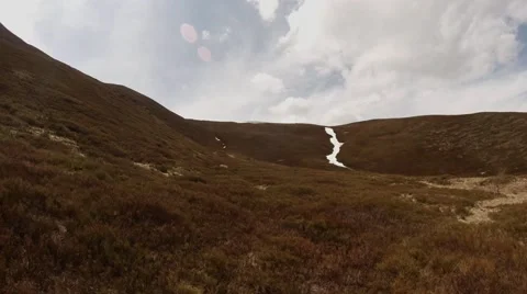 Withered Grass and a Little Bit of Snow on Top of the Mountain Under the Gray Stock Footage 63962879