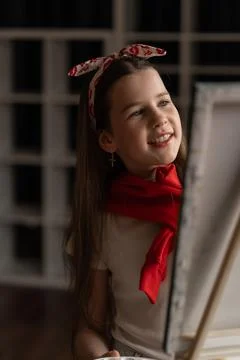 Within her art studio, an inspired girl joyfully paints on a canvas, expres.. Stock Photos