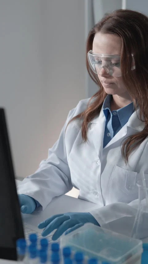 Within a laboratory setting, a female scientist is engaged in research Stock Footage 284711771