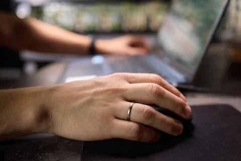 Within a tech environment, a professional is busily working on a laptop while Foto stock