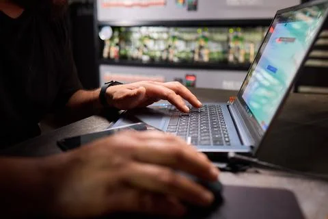 Within a tech environment, a professional is busily working on a laptop while Foto stock