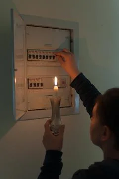 Without electricity to the electric panel by candlelight Stock Photos