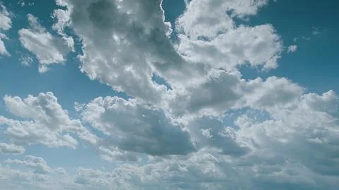 Witness the breathtaking dynamic cloud patterns gracefully drifting beneath the Stock Photos