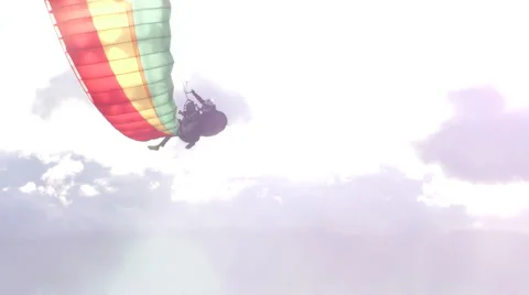 Witness the breathtaking sight as a paraglide gracefully turns and vanishes into 動画素材 59211258