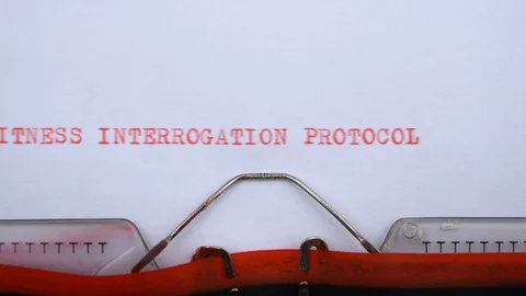 Witness interrogation protocol- phrase printed on an old typewriter, red letters Video stock 128400457