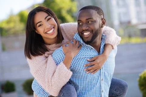Witty string guy giving his girl a ride Stock Photos
