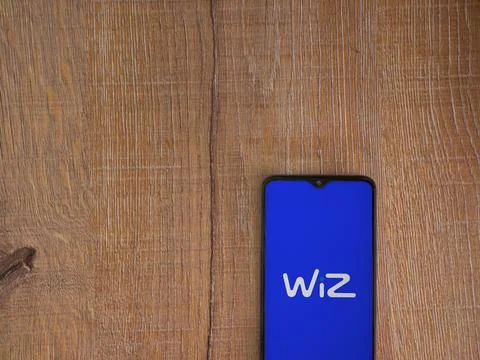 WIZ app launch screen on smartphone on wooden background Stock Photos