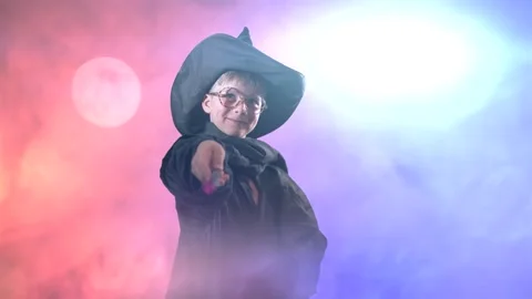 A wizard boy with a magic wand in a Halloween costume Stock Footage 284888445
