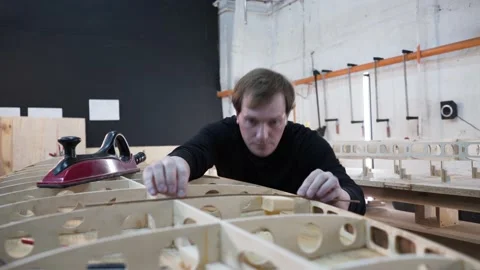 Wizard checks the evenness of skeleton surf Board Stock Footage 132348777