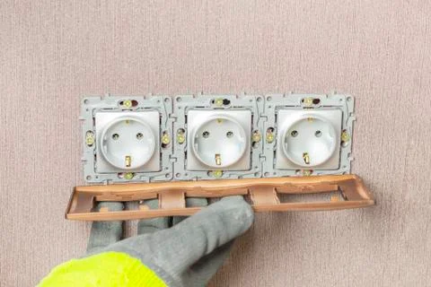 The wizard completes the installation of outlets. Sets the decorative brown f Stock Photos