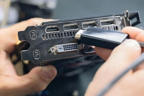 The wizard connects the computer's video card using an HDMI cable Stock Photos