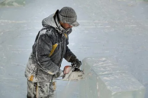 The wizard cuts figures from the ice chainsaw 스톡 사진