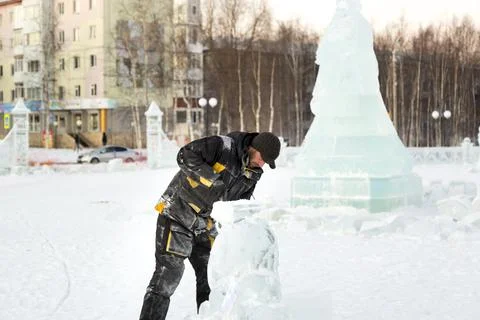 The wizard cuts figures from the ice chainsaw 스톡 사진