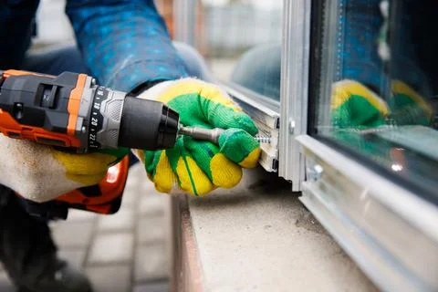 The wizard is engaged in installing windows. Repair work. Stock Photos